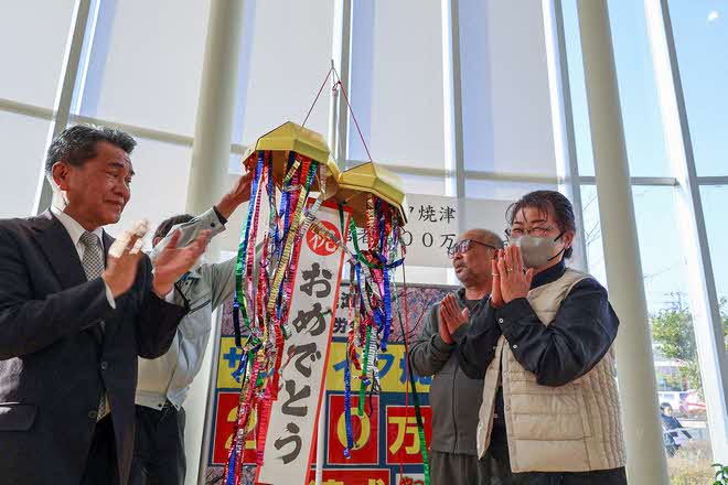 くす玉を割り200万人目を祝う市長と谷村さん